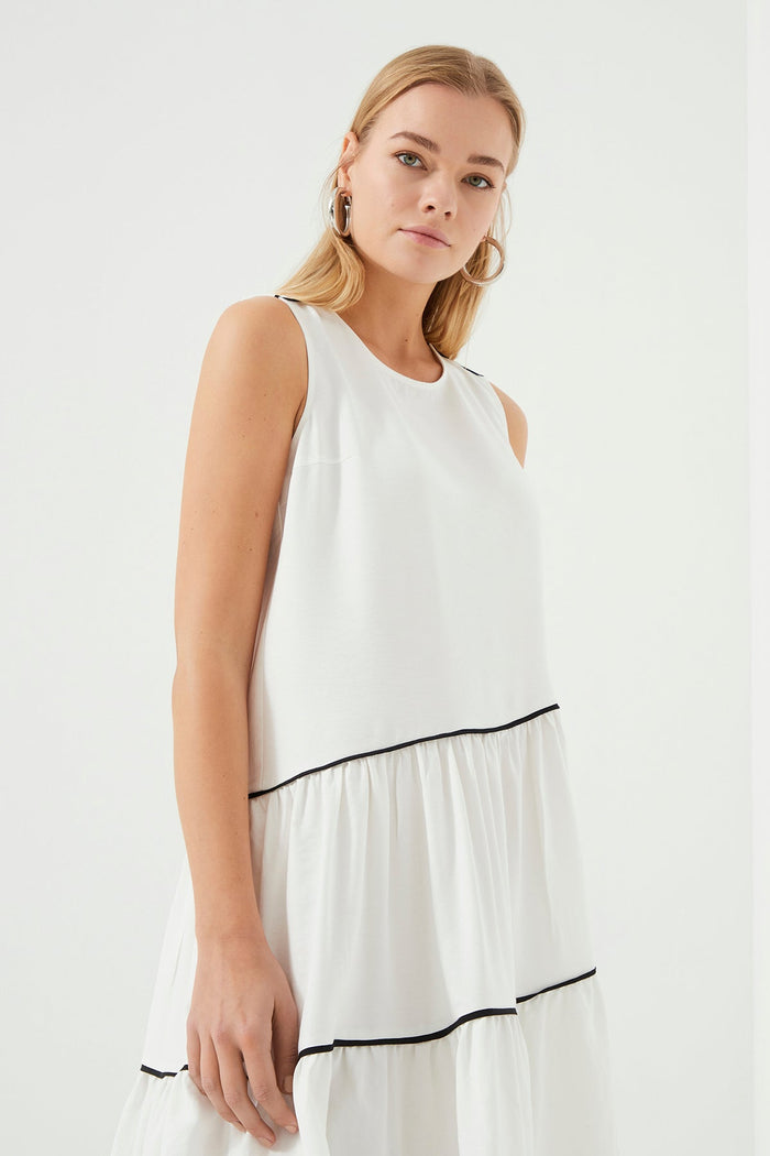 Schwarzes Kleid mit Rüschen und weißen Paspeln